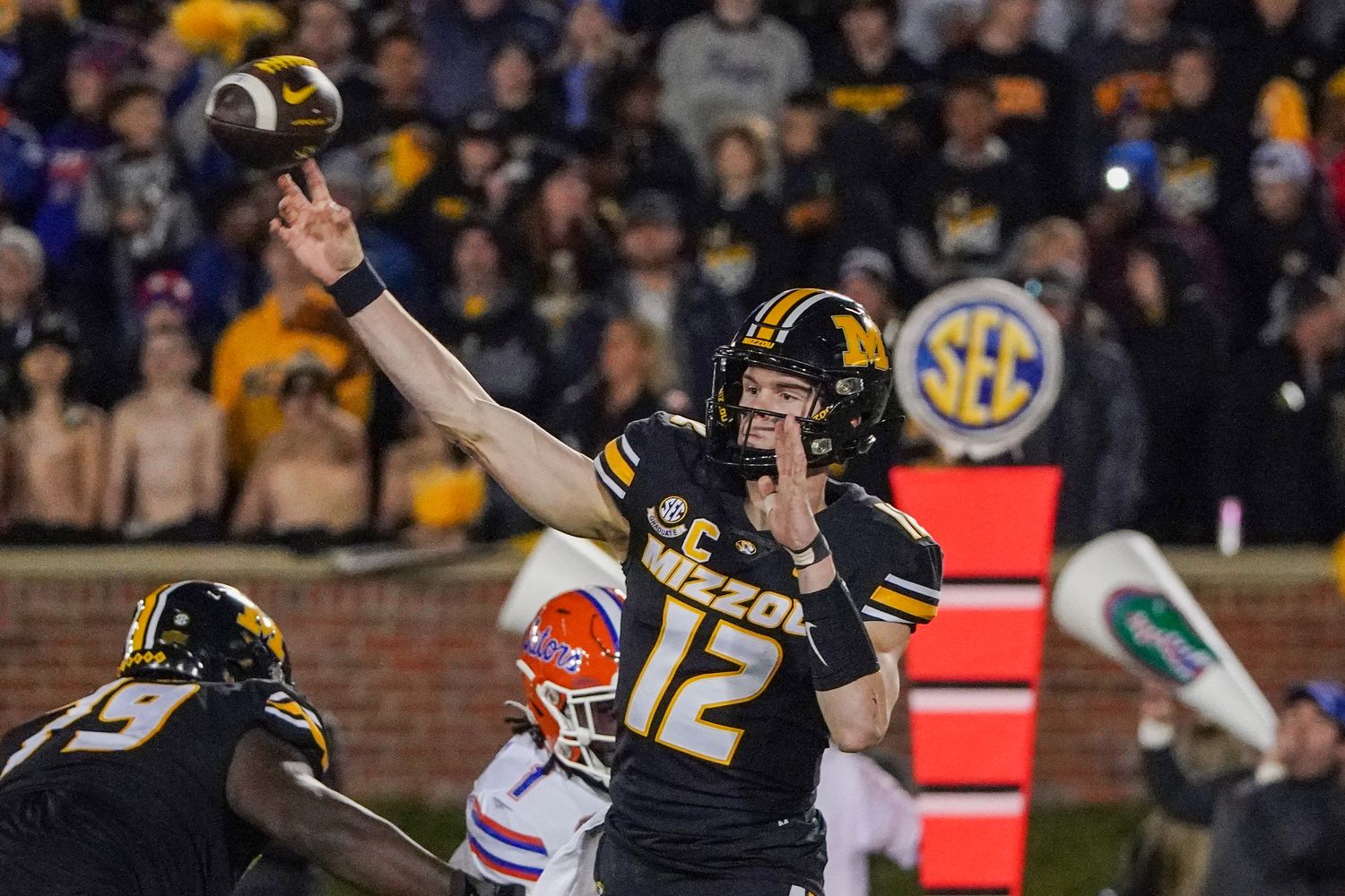 Nov 18, 2023; Columbia, Missouri, USA; Missouri Tigers quarterback Brady Cook (12) throws a pass against the Florida Gators during the first half at Faurot Field at Memorial Stadium. Mandatory Credit: Denny Medley-USA TODAY Sports  